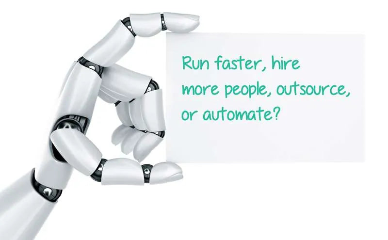 Robot hand holding a card about automation