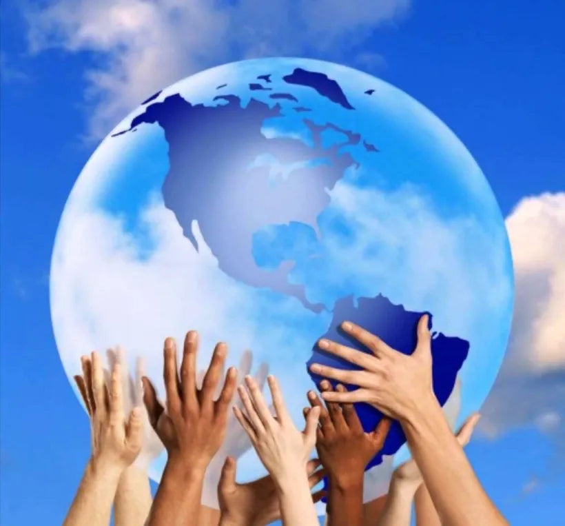 Children's hands holding up a globe